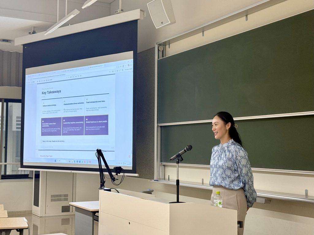 Rachel Leng sharing business insights during a lecture at Soka University.